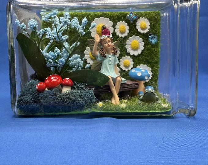 Tiny fairy in a glass vase