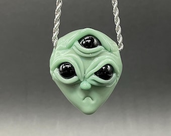 Time manipulating three eye alien pendant