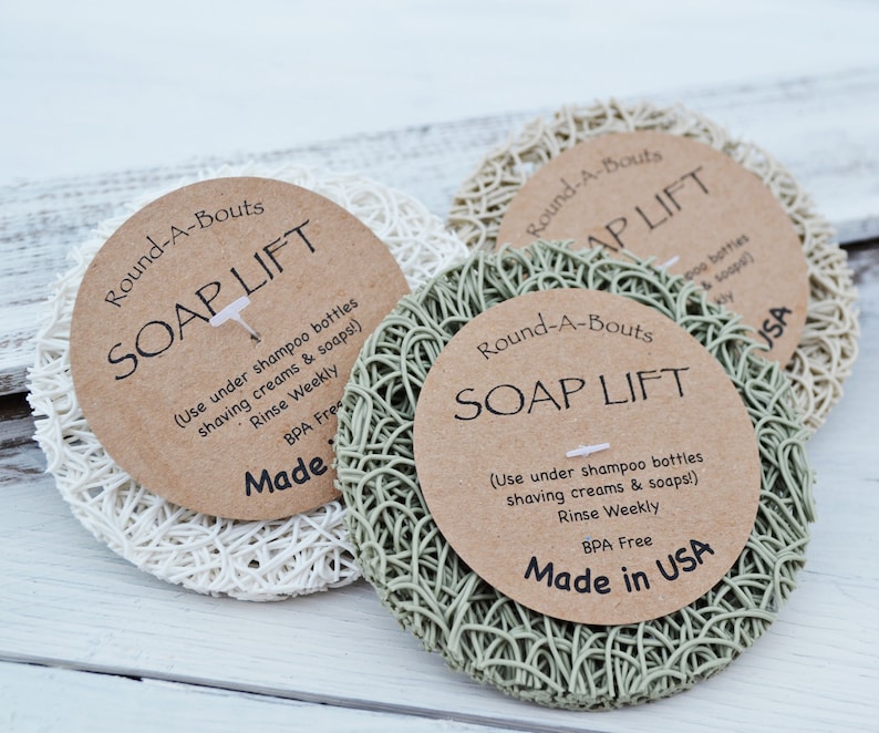 May include: Three white, green, and beige soap lift pads with brown paper labels that read "Round-A-Bouts Soap Lift" and instructions for use. The labels also say "Made in USA" and "BPA Free".