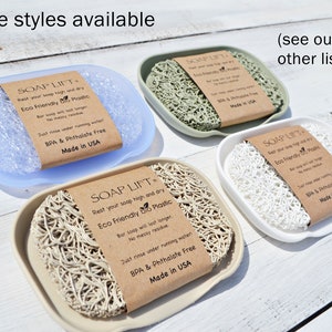 May include: Four soap dishes made of different materials, each with a brown label that reads "SOAP LIFT" and "Rest your soap high and dry Eco Friendly Bio Plastic". The label also includes the text "Just rinse under running water BPA & Phthalate Free Made in USA".