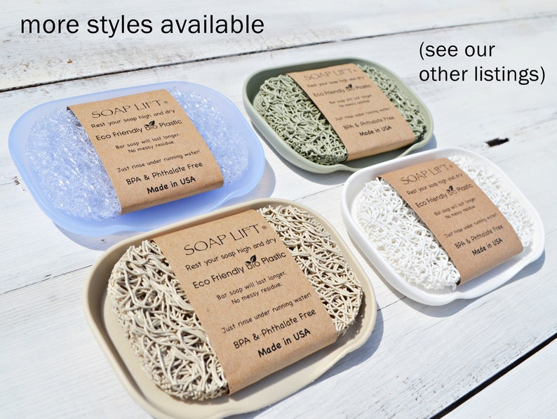 May include: Four soap dishes made of different materials, each with a brown label that reads "SOAP LIFT" and "Rest your soap high and dry Eco Friendly Bio Plastic". The label also includes the text "Just rinse under running water BPA & Phthalate Free Made in USA".