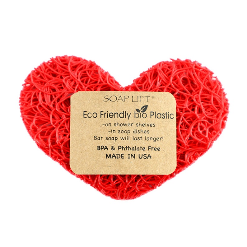 May include: Red heart-shaped soap saver made of eco-friendly bio plastic. The saver is designed to help bar soap last longer. It is BPA and Phthalate free and made in the USA. The text on the label reads: "SOAP LIFT Eco Friendly bio Plastic -on shower shelves -in soap dishes Bar soap will last longer! BPA & Phthalate Free MADE IN USA"