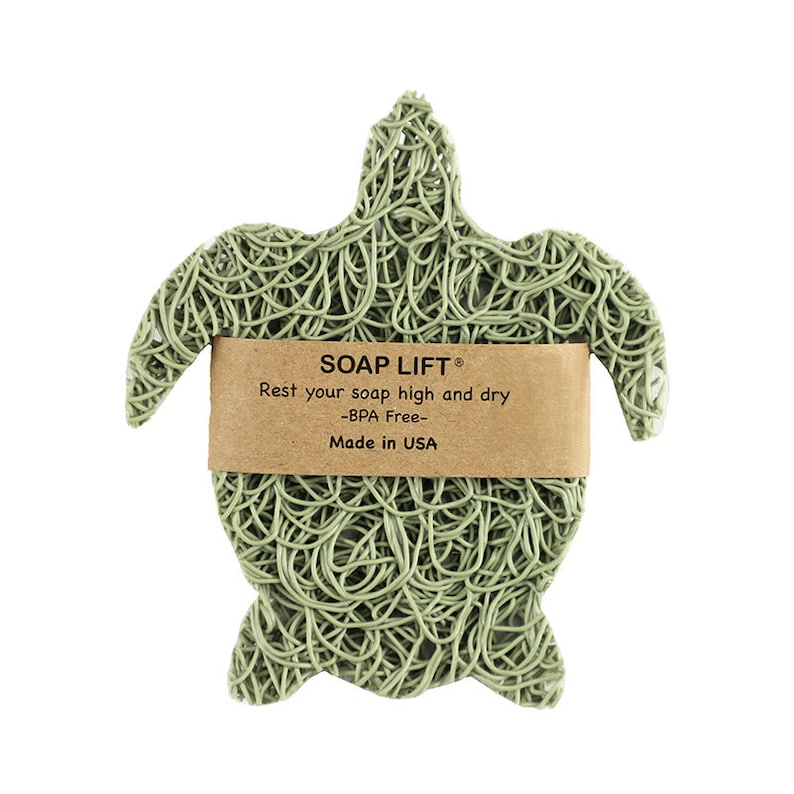May include: Green turtle-shaped soap dish made of woven plastic. The dish has a label that reads "SOAP LIFT&reg; Rest your soap high and dry -BPA Free- Made in USA".