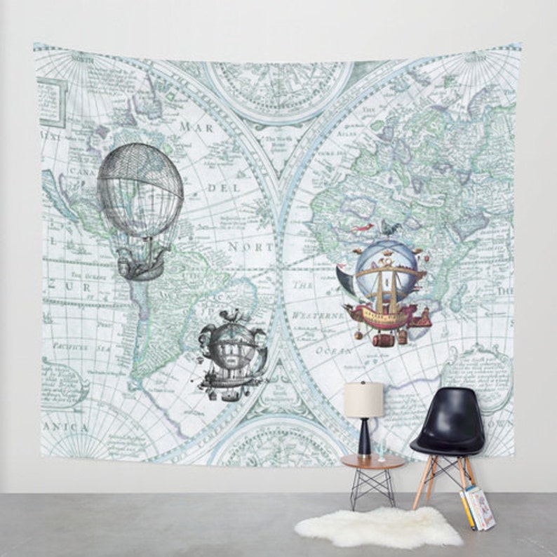 May include: A vintage world map tapestry with a blue and green color scheme. The map features three airship illustrations, each with a unique design. The airship illustrations are in the center of the map, with the map extending out to the edges of the tapestry.