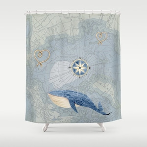May include: A shower curtain featuring a vintage map design in shades of blue and gray. It includes a compass rose, rope heart accents, and a blue whale illustration. The nautical theme is prominent.