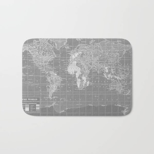 May include: A vintage world map in white on a gray background. The map shows the continents and oceans of the world. The map is labeled "THE WORLD" and includes a key with different colors and symbols.
