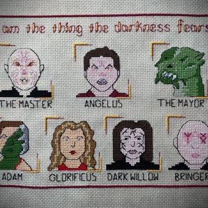 May include: Cross-stitch artwork featuring characters from a television show. The text "I am the thing the darkness fears" is at the top. Below are images of The Master, Angelus, The Mayor, Adam, Glorificus, Dark Willow, and Bringers.