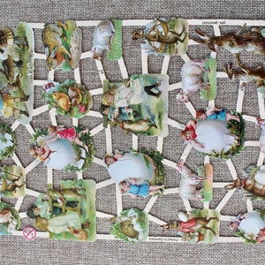 May include: A set of vintage paper cutouts featuring children, animals, and Easter eggs. The cutouts are printed on white paper with colorful illustrations. The set includes a rabbit, a lamb, a chicken, a goose, a boy, a girl, and an egg.