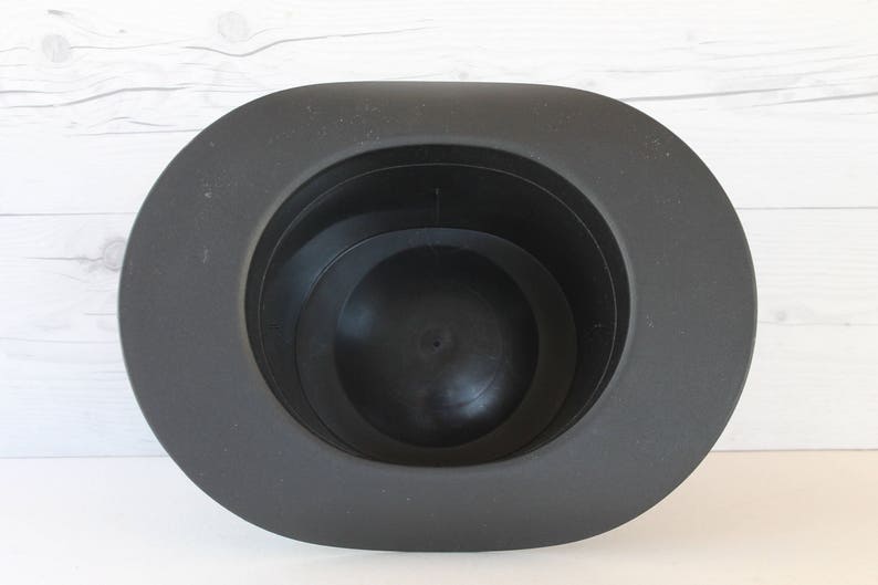 May include: A black felt hat with a wide brim and a deep crown. The hat is made of a soft, pliable material and has a smooth, polished finish.