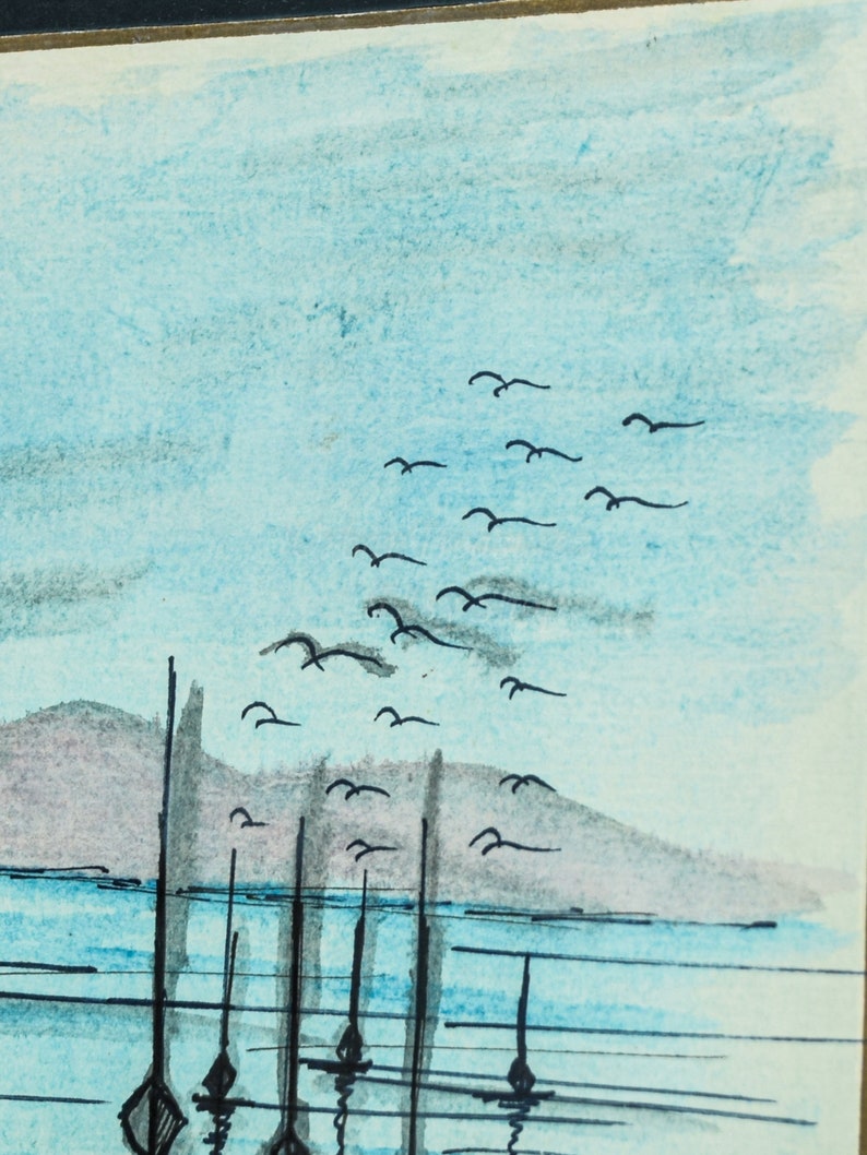 May include: A watercolor painting of a seascape with a row of boats in the water and a flock of birds flying overhead. The sky is a light blue color and the water is a darker blue. The boats are black and the birds are black.