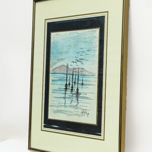 May include: Framed watercolor painting of a seascape with a row of boats in the water and a flock of birds flying overhead. The painting is signed "G.Hoffman" in the bottom right corner.