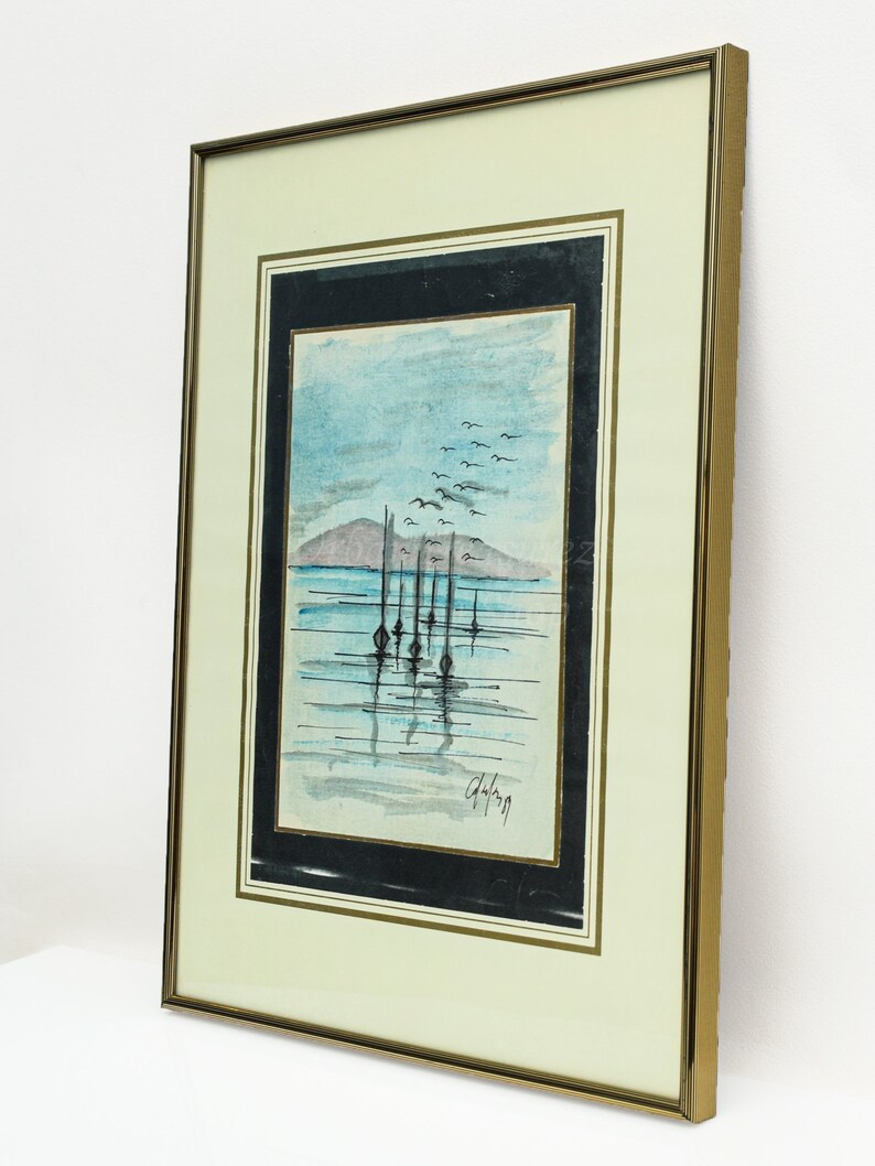 May include: Framed watercolor painting of a seascape with a row of boats in the water and a flock of birds flying overhead. The painting is signed "G.Hoffman" in the bottom right corner.