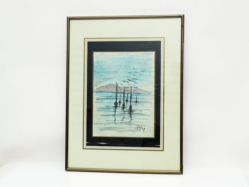 May include: A framed watercolor painting of a seascape with a distant mountain range, a flock of birds flying overhead, and several sailboats in the water. The painting is signed "Chery" in the bottom right corner.