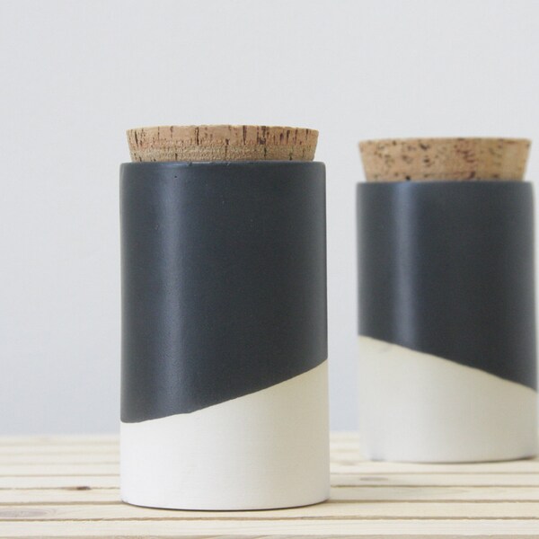 Ceramic jar with a cork lid in white and black matte glaze.