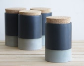 Small ceramic jar with cork lid in gray with black matte glaze.