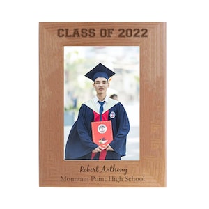 May include: A wooden picture frame with a graduation photo of a person wearing a cap and gown. The frame has the text "Class of 2022" at the top and "Robert Anthony Mountain Point High School" at the bottom.