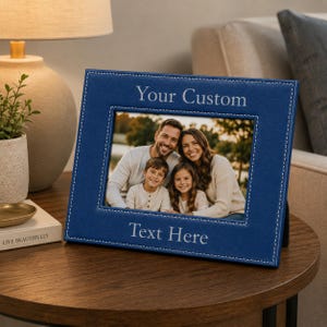 May include: A rectangular blue photo frame with white stitched edges. The frame features the text Your Custom at the top and Text Here at the bottom. Inside the frame is a photograph of a family of four, including two adults and two children.