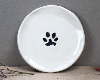 Paw Print. Small Plain Saucer With A Paw Print. Hand-Built Ceramic Saucer. Recycled Clay. Measures Roughly 3 3/4" In Diameter.