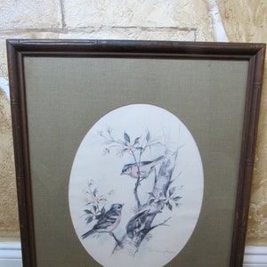 May include: A framed watercolour painting of two bluebirds perched on a branch with pink blossoms. The painting is signed "Ed Willoughby" in the bottom right corner.