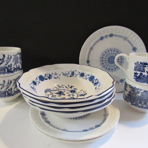 May include: A set of blue and white willow pattern china, including a bowl, saucer, and teacups. The china features a delicate floral design and a blue rim.