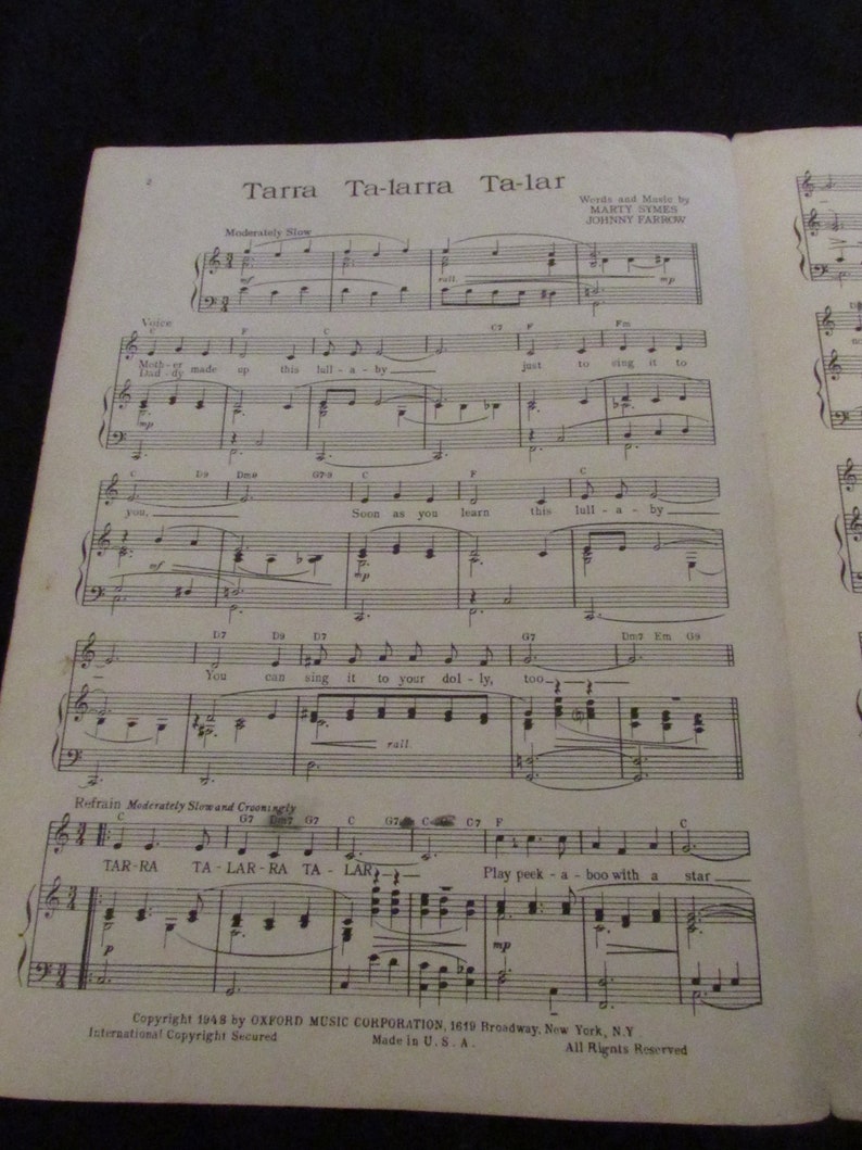May include: Sheet music for the song "Tarra Ta-larra Ta-lar" by Marty Symes and Johnny Farrow. The music is written in a standard musical notation format with lyrics printed below the notes. The song is a lullaby.