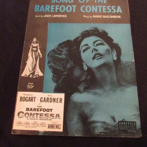 May include: A vintage sheet music cover for the song "Song of the Barefoot Contessa" from the 1954 film "The Barefoot Contessa". The cover features a photo of Ava Gardner, who starred in the film, and the title of the song in large, bold letters.