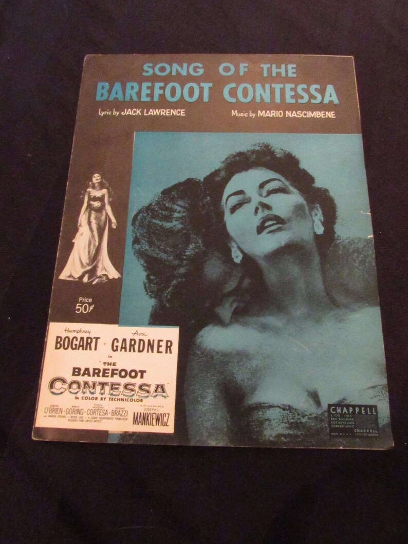 May include: A vintage sheet music cover for the song "Song of the Barefoot Contessa" from the 1954 film "The Barefoot Contessa". The cover features a photo of Ava Gardner, who starred in the film, and the title of the song in large, bold letters.