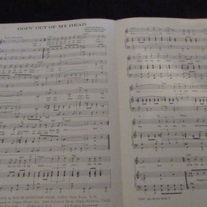 May include: A sheet music book with the title "Goin' Out of My Head" printed on the cover. The music is written in black ink on white paper. The sheet music is for a song by the South Mountain Music Corp.