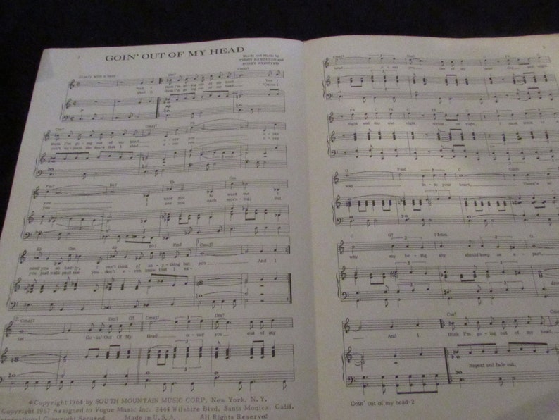 May include: A sheet music book with the title "Goin' Out of My Head" printed on the cover. The music is written in black ink on white paper. The sheet music is for a song by the South Mountain Music Corp.