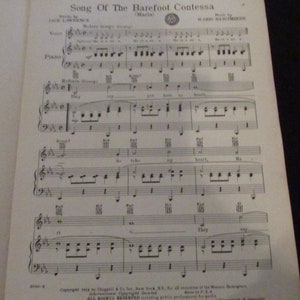 May include: A sheet music score for the song "Song of the Barefoot Contessa" by Jack Lawrence and Mario Nascimbene. The music is written in standard notation with lyrics printed below the musical notes. The title of the song is printed in large, bold letters at the top of the page.