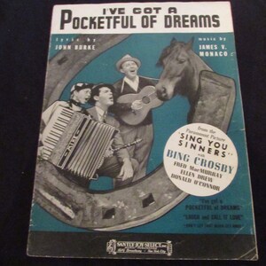 May include: A vintage sheet music cover for the song "I've Got a Pocketful of Dreams" from the Paramount Picture "Sing You Sinners" starring Bing Crosby, Fred MacMurray, Ellen Drew, and Donald O'Connor. The cover features a black and white photo of the cast singing and playing musical instruments.