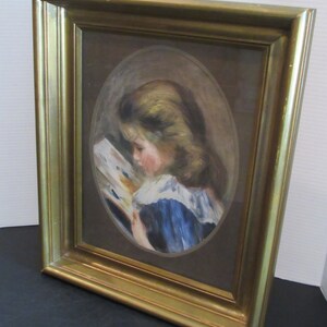 May include: A framed painting of a young girl in a blue dress reading a book. The painting is in an oval frame and is set against a brown background.