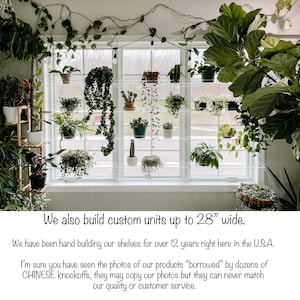 May include: A window with a white frame and multiple shelves holding various potted plants. The shelves are made of clear acrylic and are attached to the window frame. The text "We also build custom units up to 28" wide." is visible at the bottom of the image.