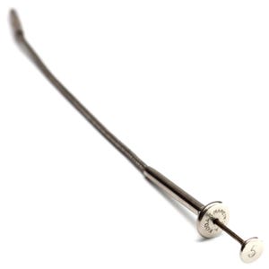 May include: A silver-toned metal cable release for a camera, featuring a flexible braided shaft and a plunger mechanism. The circular plunger head is engraved with the text KODAK MADE IN U.S.A. and the number 5 is stamped on the top button surface.