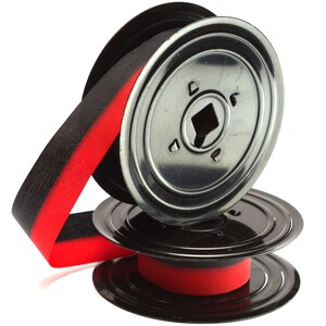 May include: A spool of black and red ribbon with a metal reel. The ribbon is black with a red stripe along one edge. The reel is silver-colored metal with a square hole in the center.