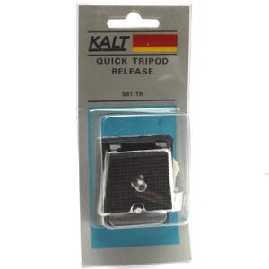 May include: A KALT Quick Tripod Release 581-TR in original retail packaging. The device is a black and silver metal camera mounting plate with a textured rubber grip surface and a central screw, encased in a clear plastic blister pack.