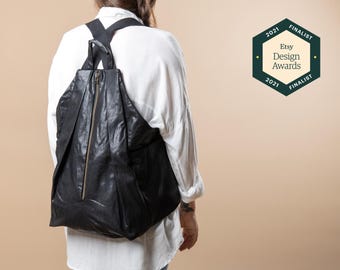Mochila vegana negra: bolso de viaje de piel sintética con correas ajustables.