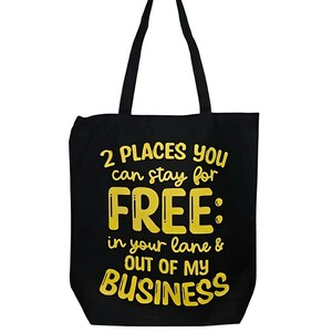 May include: Black canvas tote bag with yellow text that reads "2 PLACES YOU can stay for FREE: in your lane & OUT OF MY BUSINESS"