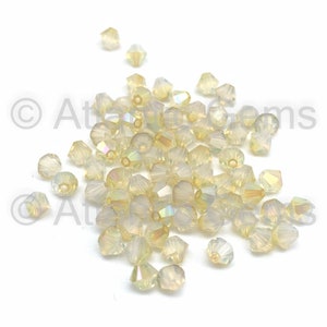 White Opal Lemon Coated AMC 6mm Swarovski 5328 Bicone  - 72pcs