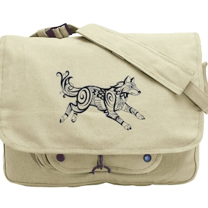 May include: A beige canvas messenger bag with a black and white patterned wolf design. The bag has a flap closure and a front pocket.