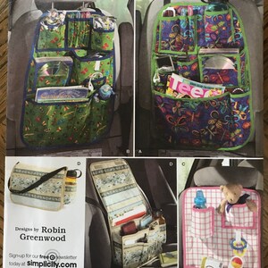 May include: A sewing pattern for car seat organizers. The pattern includes four different designs: a green organizer with butterflies, a blue organizer with butterflies, a beige organizer with floral print, and a pink organizer with a checkered pattern. The pattern is from Simplicity and is size one.