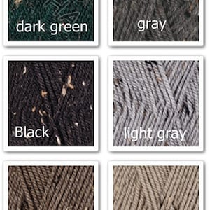 May include: A collection of yarn samples in various colors, including dark blue, red, dark green, gray, black, light gray, milk chocolate, beige, oatmeal, and white. Each yarn sample has a speckled texture.