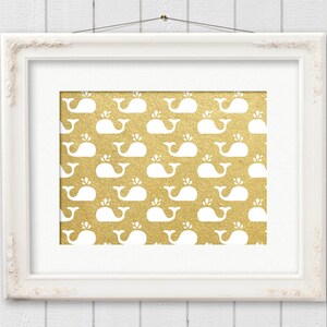 May include: A white framed picture with a gold background and a repeating pattern of white whales.