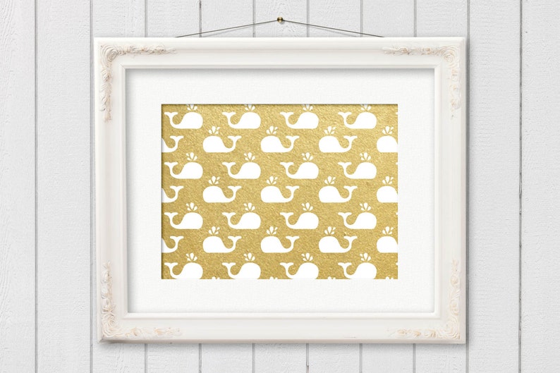 May include: A white framed picture with a gold background and a repeating pattern of white whales.