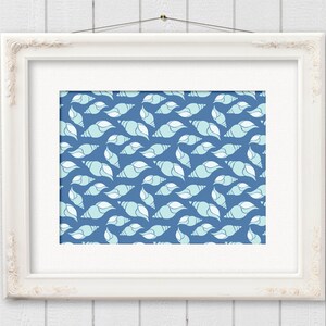 May include: A framed print featuring a repeating pattern of stylized seashells in shades of blue and white against a dark blue background. The artwork is displayed in a white ornate frame, creating a coastal or nautical theme.