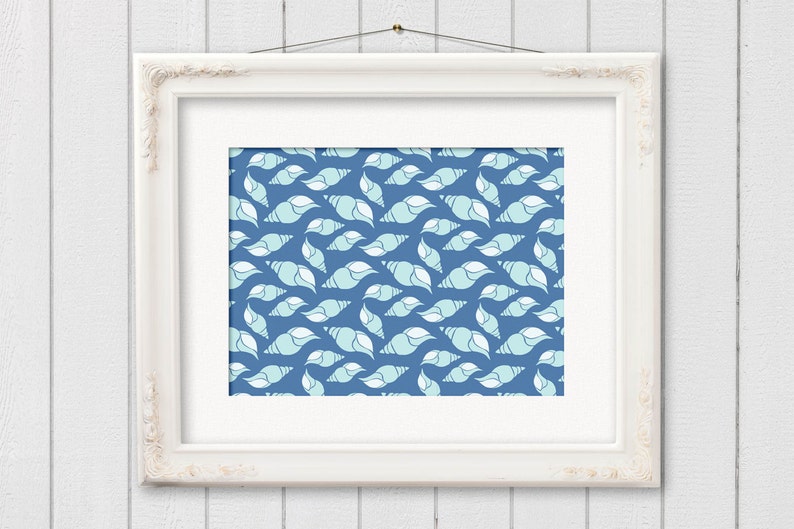May include: A framed print featuring a repeating pattern of stylized seashells in shades of blue and white against a dark blue background. The artwork is displayed in a white ornate frame, creating a coastal or nautical theme.