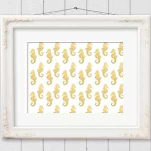 May include: A white picture frame with a gold seahorse pattern on a white background.