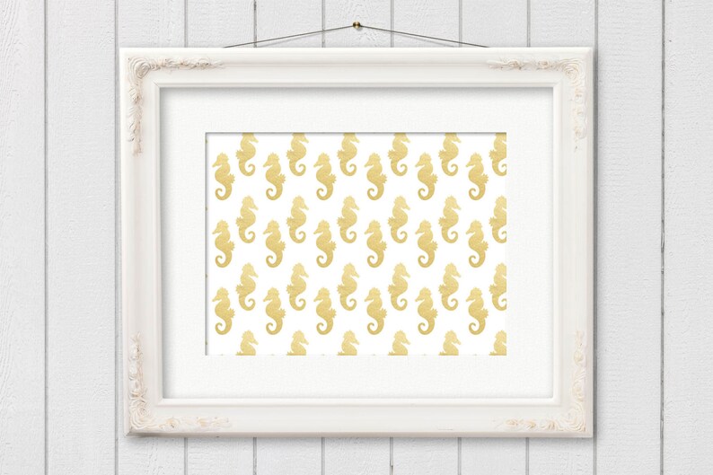 May include: A white picture frame with a gold seahorse pattern on a white background.