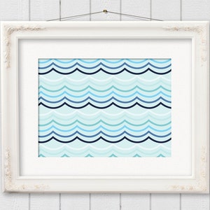 May include: A framed print featuring a repeating wave pattern in shades of blue and teal. The artwork is displayed in a white, ornate frame, hanging against a white wooden background. The design evokes a nautical or coastal theme.