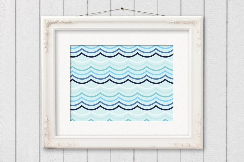 May include: A framed print featuring a repeating wave pattern in shades of blue and teal. The artwork is displayed in a white, ornate frame, hanging against a white wooden background. The design evokes a nautical or coastal theme.